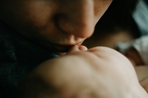 mother kissing baby