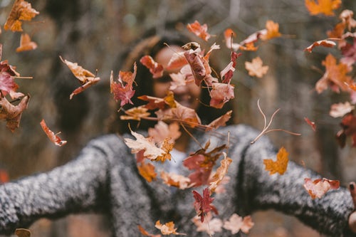 woman throwing leaves