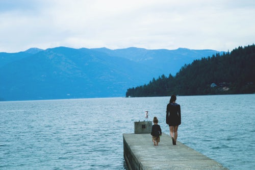 Mom with child walking on dock